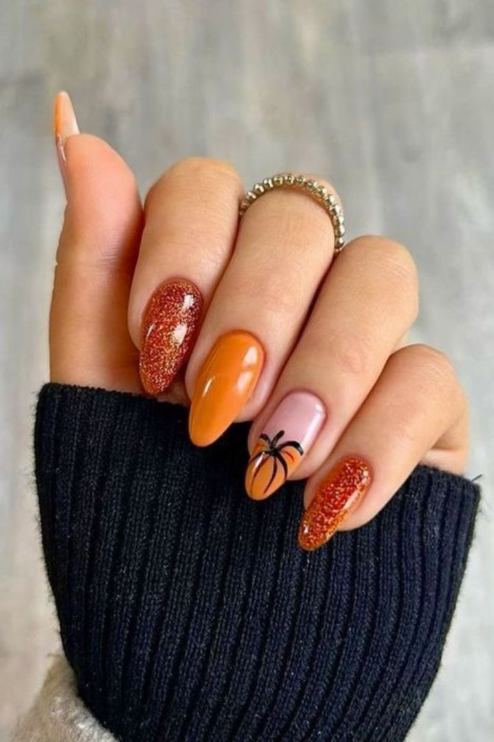 Festive Autumn Nail Design: Warm Colors and Pumpkin Accents Capture Fall's Essence