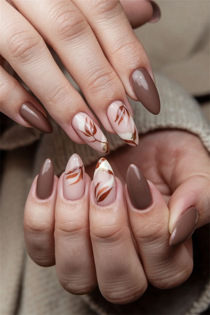 Sophisticated Nail Design Blending Rich Browns, Soft Neutrals, and Nature-Inspired Leaf Patterns.