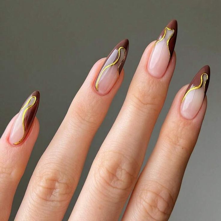 Chic Almond-Shaped Nails: Rich Brown and Nude Tones with Glamorous Gold Accents.