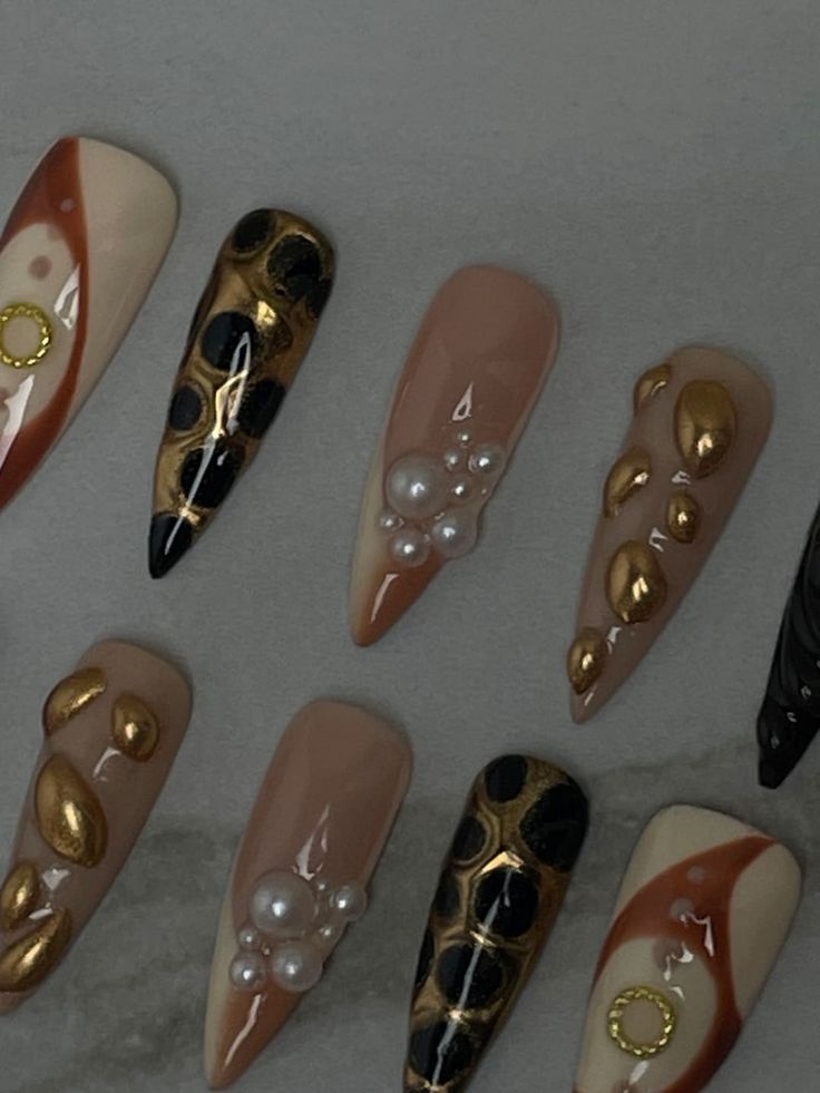 Chic Nail Art Blending Neutral and Dark Shades with Gold Accents and Unique Textures