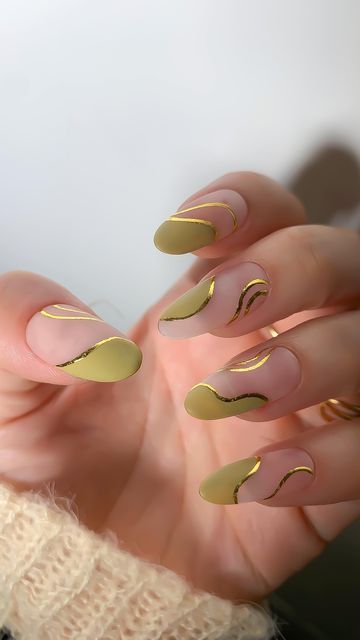 Chic Almond-Shaped Nail Design with Soft Pastel Yellow and Metallic Gold Accents.