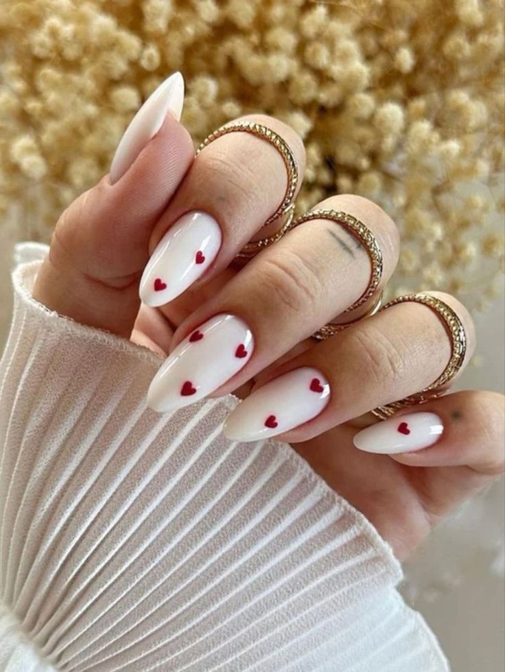 Chic Almond-Shaped Nail Design with Glossy White Polish and Red Heart Accents