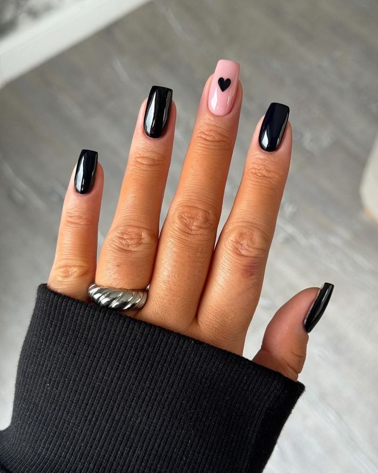 Elegant Chic Nail Design: Glossy Black and Soft Pink with Playful Heart Accent.