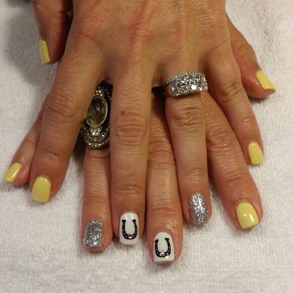 Cheerful Yellow Nail Design with Glittering Silver Accents and Playful Horseshoe Motif.