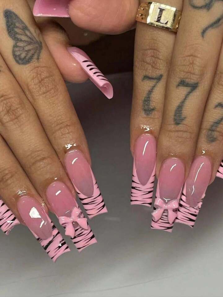 Trendy Nail Design: Elegant Pink and Bold Zebra Stripes with Playful Bows