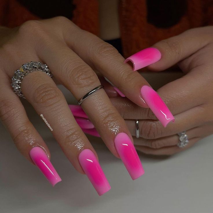 Vibrant Ombre Pink Nails: A Sophisticated Gradient Design with Glossy Finish and Elegant Accents.