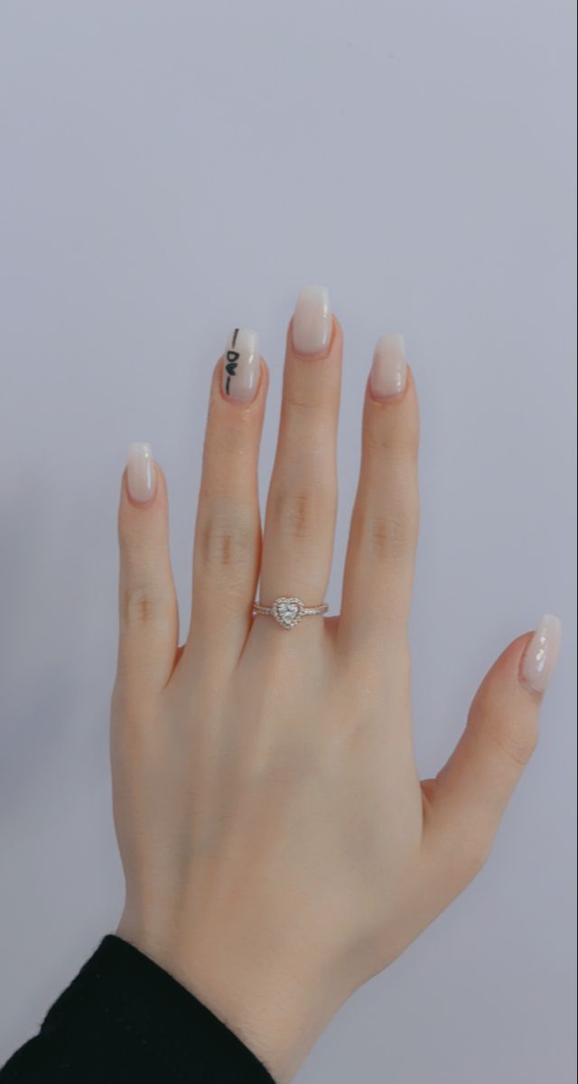 Chic Ombre Nail Design with Playful Accent and Elegant Jewelry Enhancements.