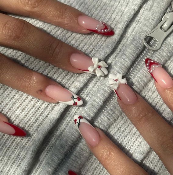 Chic Nail Design: Elegant Red Tips, Playful Bows, and Charming Cherry Motifs.