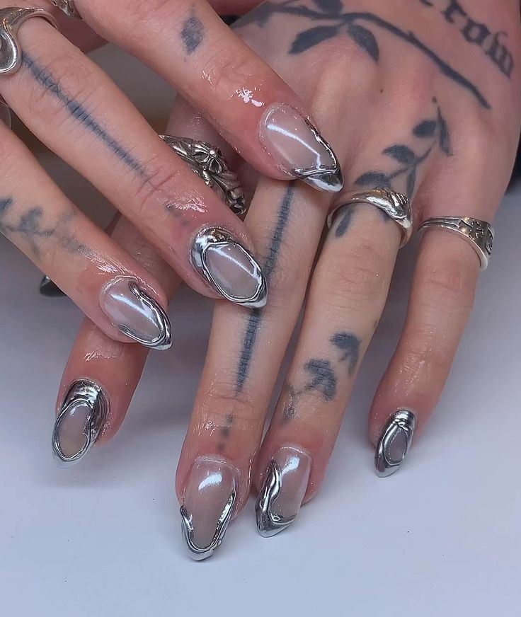 Edgy Metallic Nail Design with Glossy Finish and Intricate Silver Detailing.