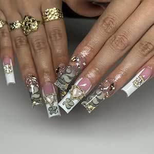 Sophisticated Nail Design: Long Sculpted Tips with Glamorous Embellishments.