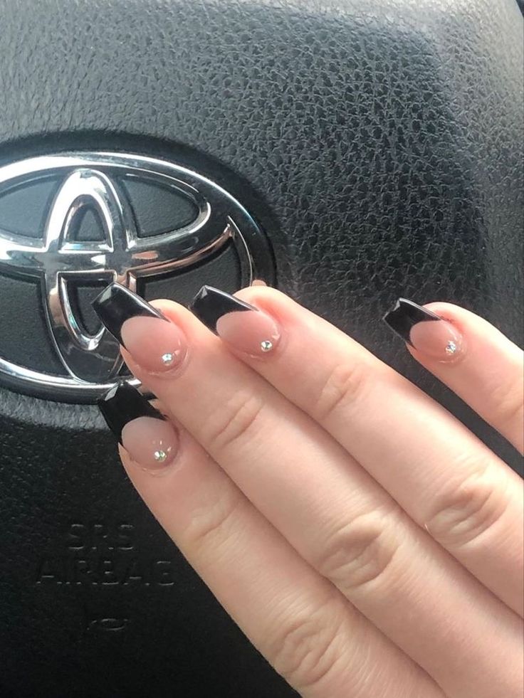 Chic Elegance: Striking Nude and Black Manicure with Gemstone Accents