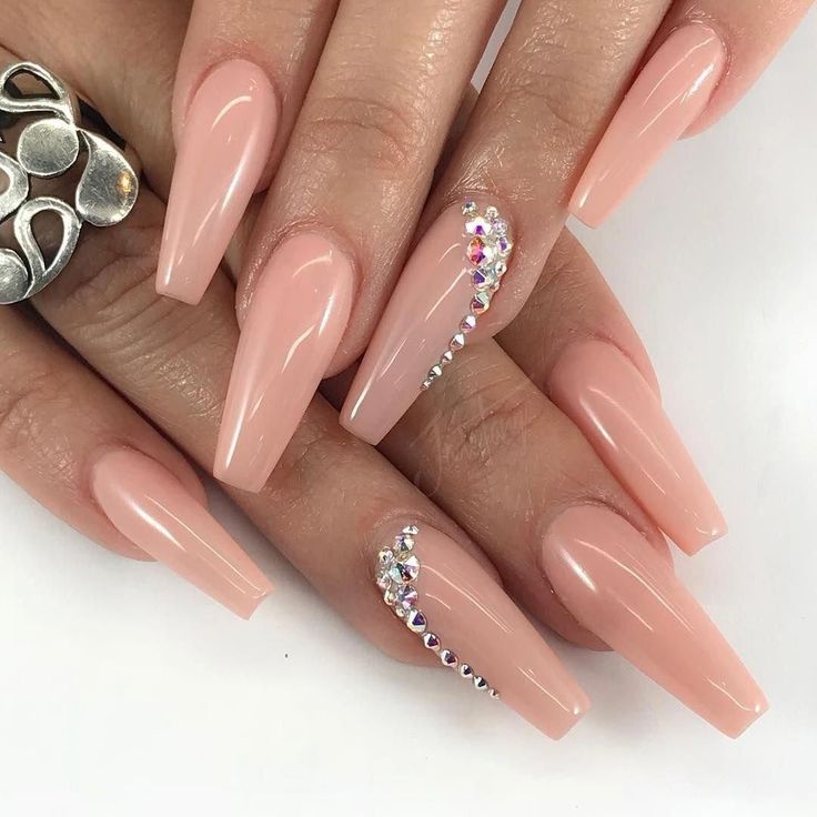 Chic Almond-Shaped Nude Nails Enhanced with Sparkling Rhinestones for Elegance.