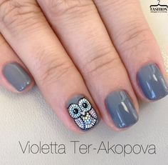 Charming Owl-Inspired Nail Design: Subtle Gray Polish with Playful Rhinestone Accent.