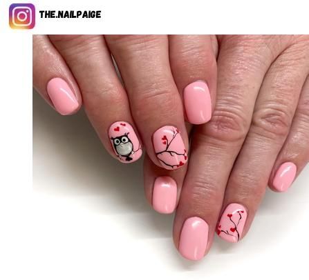 Whimsical Pink Nail Design with Playful Owl and Heart Accents.