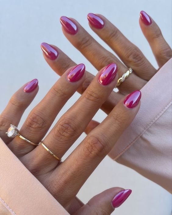 Elegant Almond-Shaped Nails in Vibrant Fuchsia with Chic Gold Ring Accents.