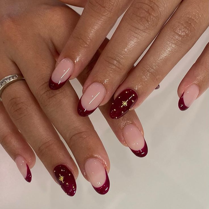 Chic Nail Design: Nude Base with Deep Burgundy Tips and Elegant Gold Accents