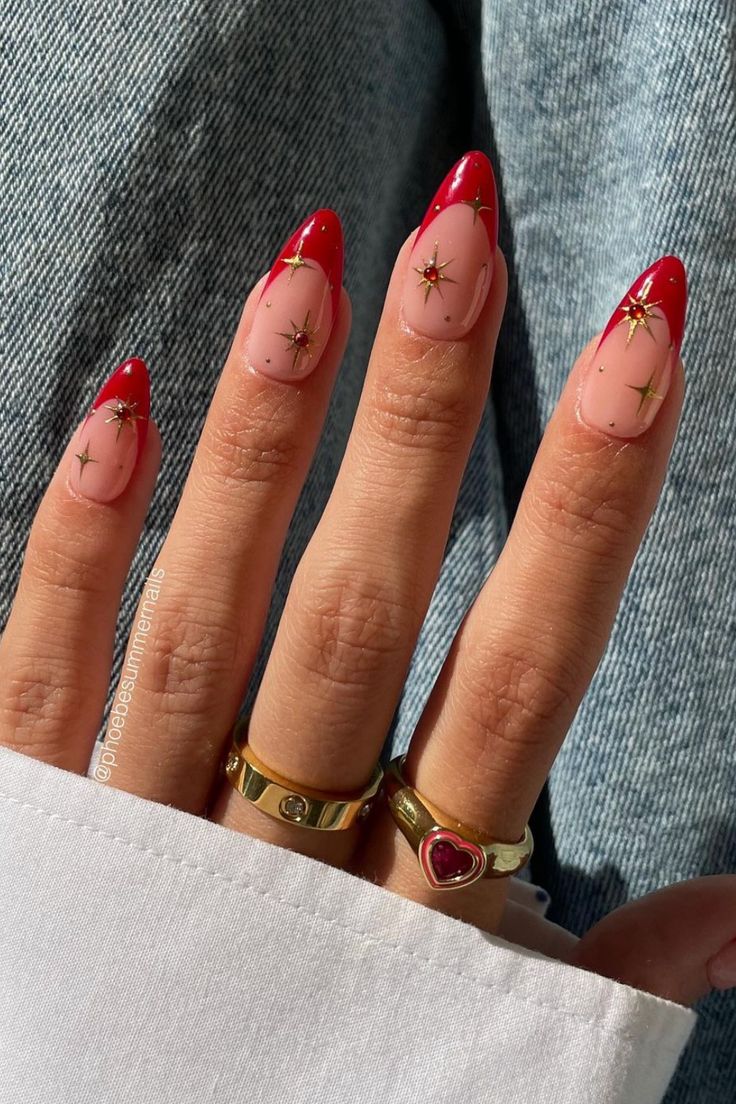 Chic Holiday Nails: Vibrant Red French Tips with Gold Star Accents