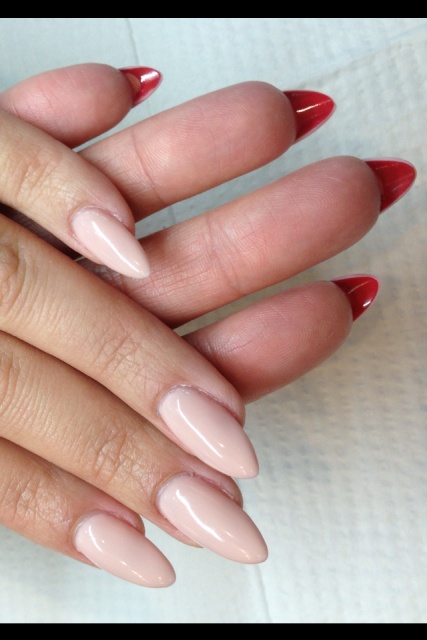 Chic Almond-Shaped Nail Design in Soft Nude and Bold Red Shades.