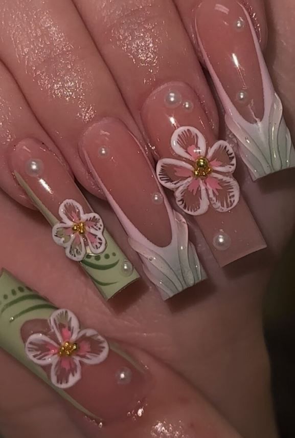 Elegant Pink and Green Floral Nail Design with Pearls for a Fresh Spring Look.