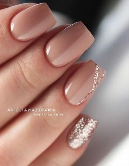 Sophisticated Nail Design: Soft Nude Base with Glittery Accent and Delicate Detailing