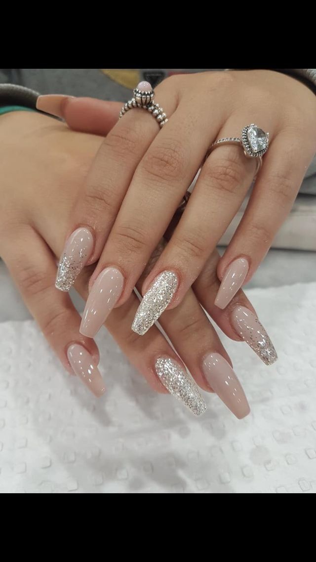 Chic Nude Almond Nail Design with Dazzling Silver Glitter Accents for Versatile Glamour.