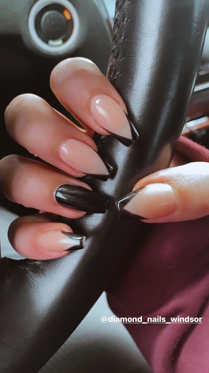 Chic Almond-Shaped Manicure: Bold Nude and Black Gradient with Sharp Tips.