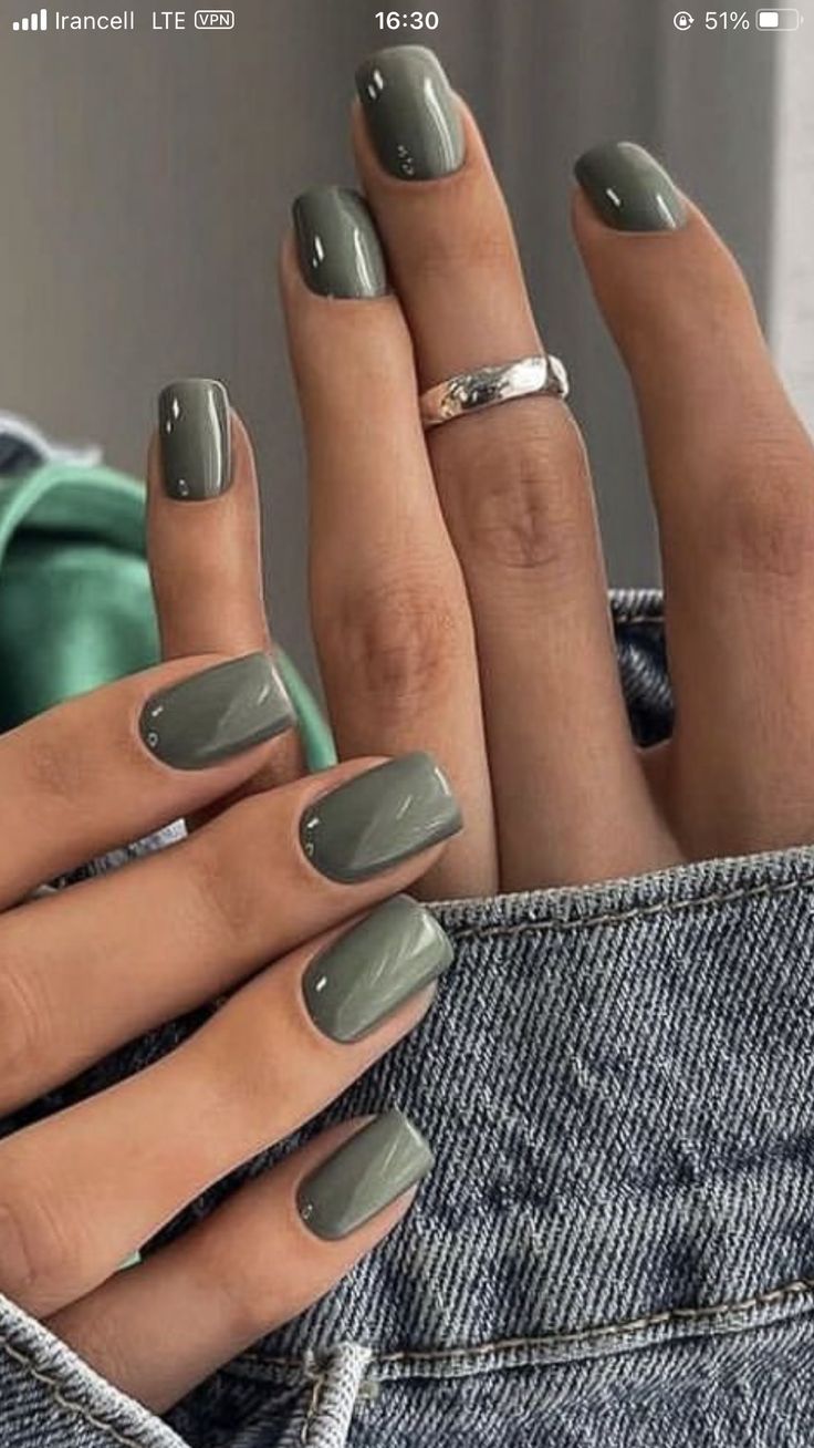 Chic Gray-Green Nail Design with Glossy Finish and Silver Ring Elegance.