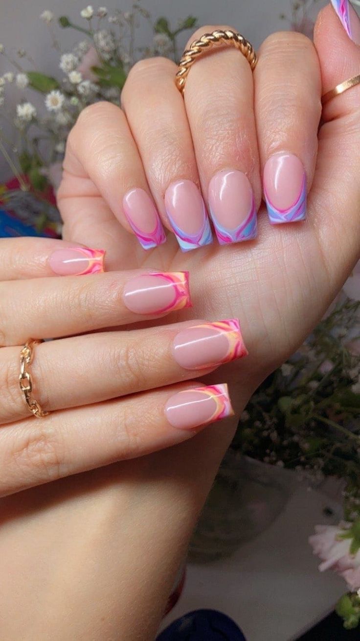 Chic Vibrant Nail Design: Elegant French Tips with Bold Marble Effect in Pink and Blue.