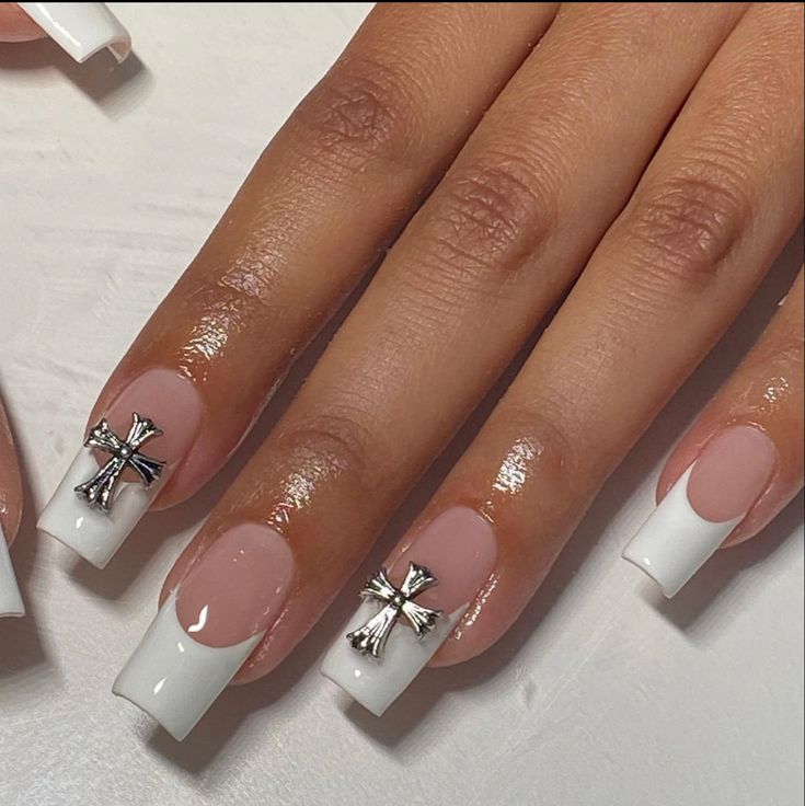 Chic French Tip Nail Design with Metallic Cross Accents for a Modern Touch