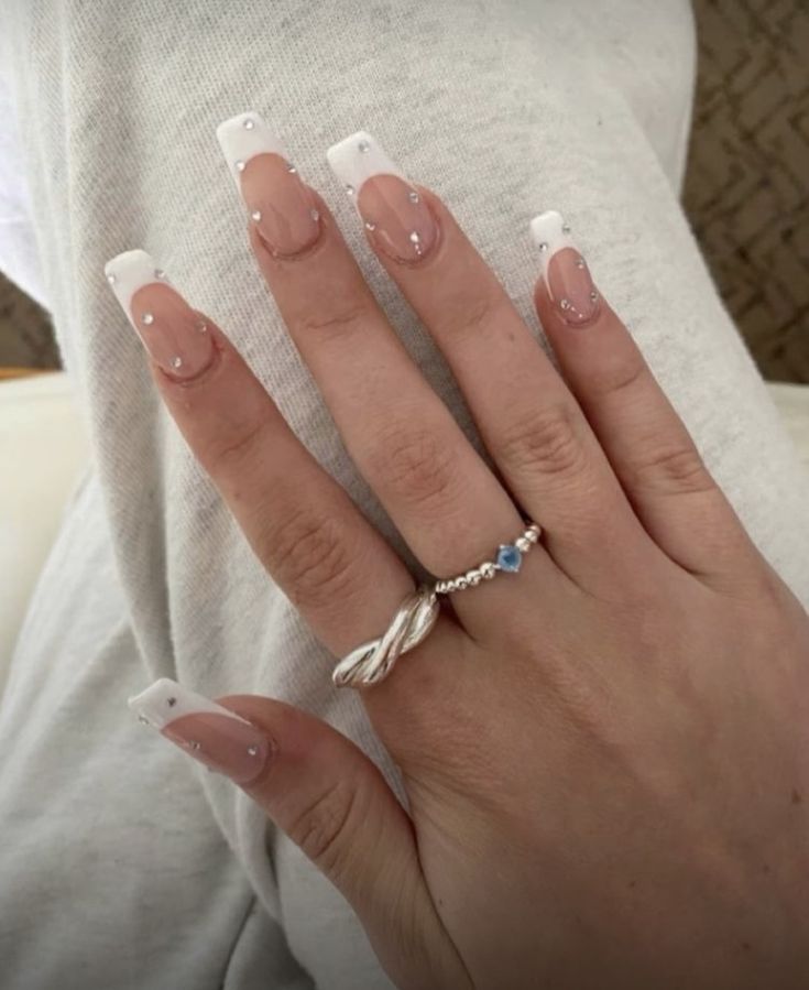 Chic Elegant French Tip Nails with Subtle Rhinestone Embellishments.