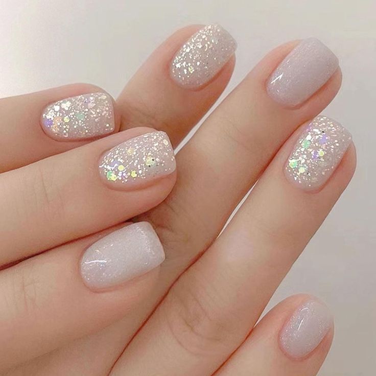 Enchanting Sparkling Nail Design with Translucent Base and Holographic Accents.