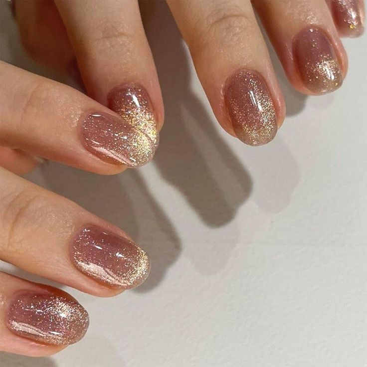 Sophisticated Gradient Nail Design with Nude and Gold Shimmer