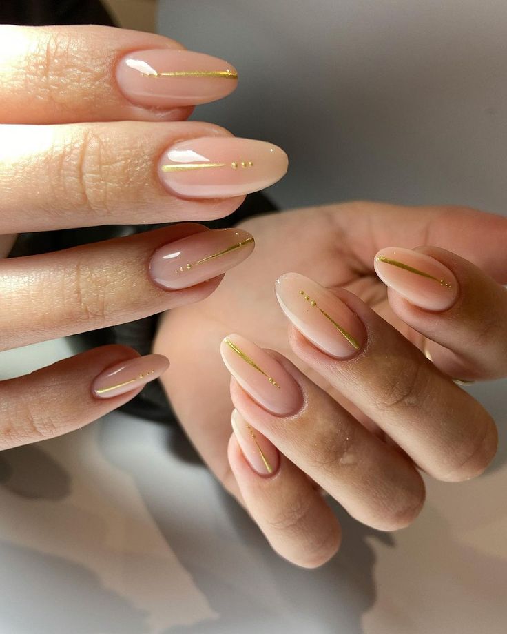 Chic Almond-Shaped Nude Nails with Elegant Gold Accents