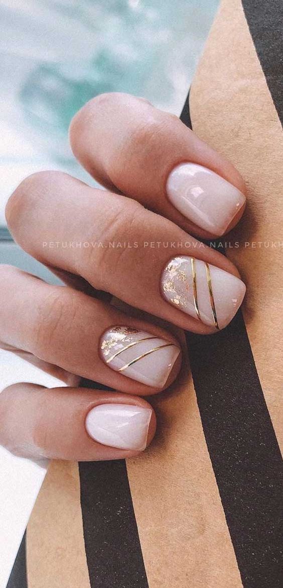 Sophisticated Elegant Nail Design: Soft White Base with Gold Accents