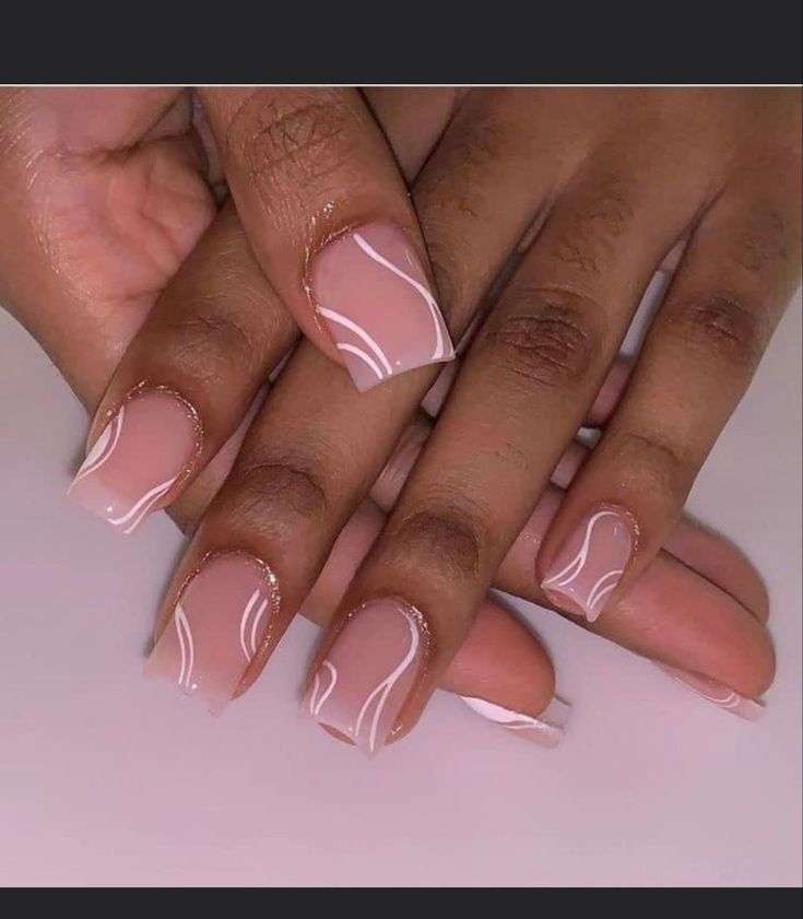 Chic Nude Nail Design with Delicate White Swirls for Timeless Elegance.