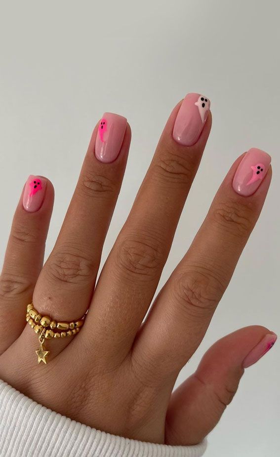 Chic Pink Nail Design: Modern Aesthetics with Geometric Shapes and Contrasting Dots.