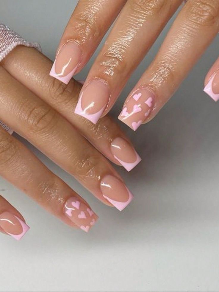 Chic Nude Nail Design with Elegant Pink French Tips and Playful Heart Patterns