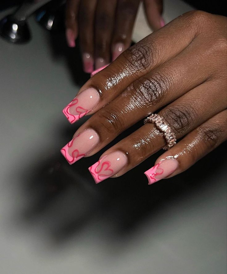 Chic Playful Nail Design: Clear Pink Base with Vibrant Heart Outlines and Sparkling Accents.