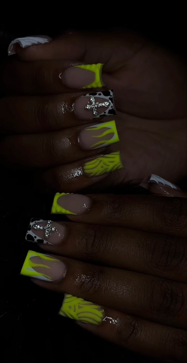 Playful Neon Yellow and Black Nail Design with Intricate Patterns and Modern Flair.