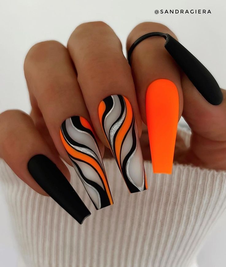 Bold and Dynamic Nail Design with Striking Colors and Patterns.