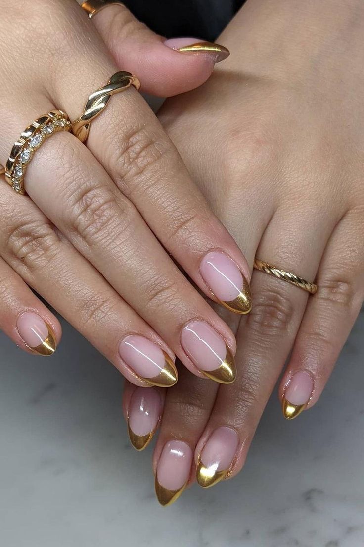 Elegant Nude Nail Design with Gold Tips and Chic Accents.