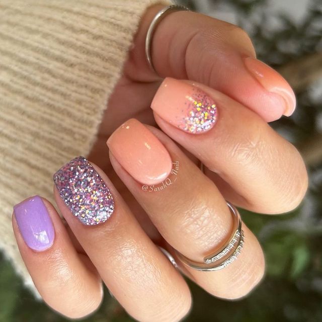 Chic Nail Design: Soft Peach Meets Vibrant Purple with Sparkling Glitter Accent.