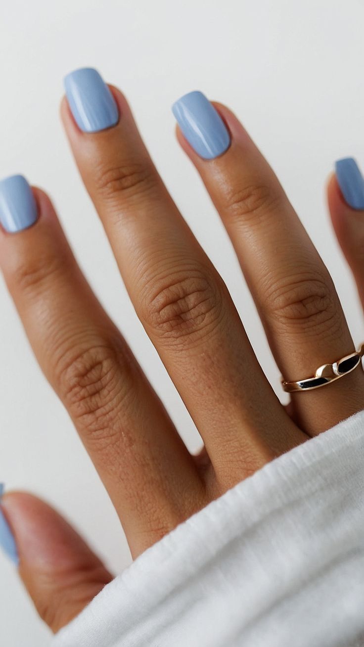 Chic Soft Blue Square Nails Accentuated with Elegant Gold Ring