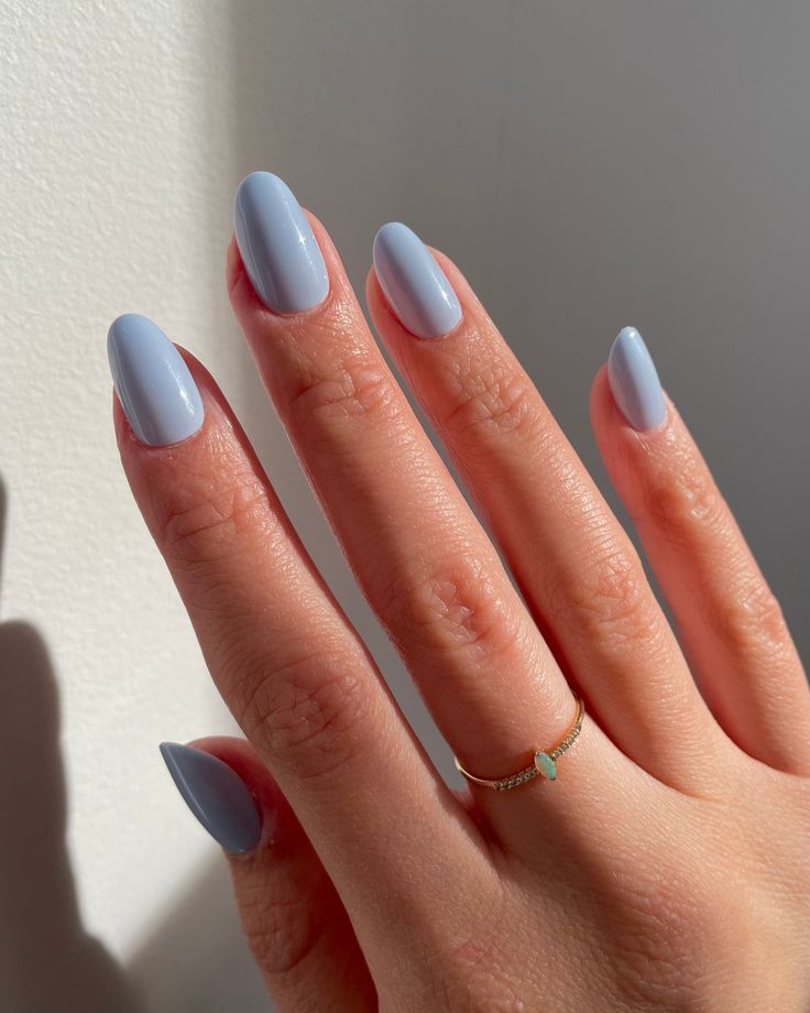 Elegant Pastel Blue Almond-Shaped Manicure with Glossy Finish and Gold Accents