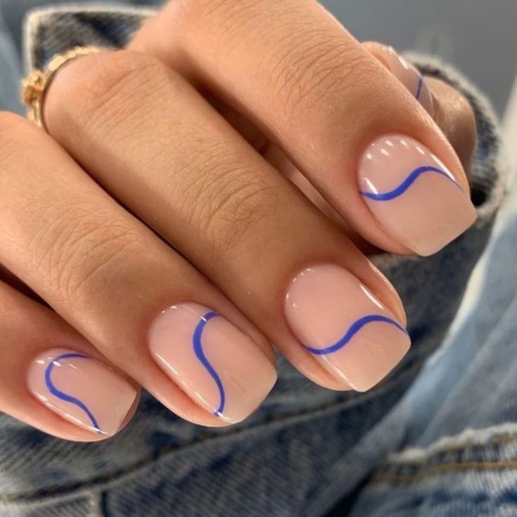 Elegant Nude Nail Design with Vibrant Blue Wave Accents for a Modern Touch.