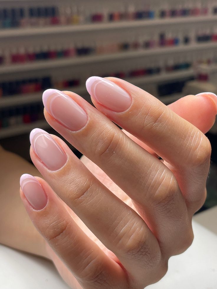 Elegant French-Inspired Nail Design with Soft Pink Hues and Subtle White Tips