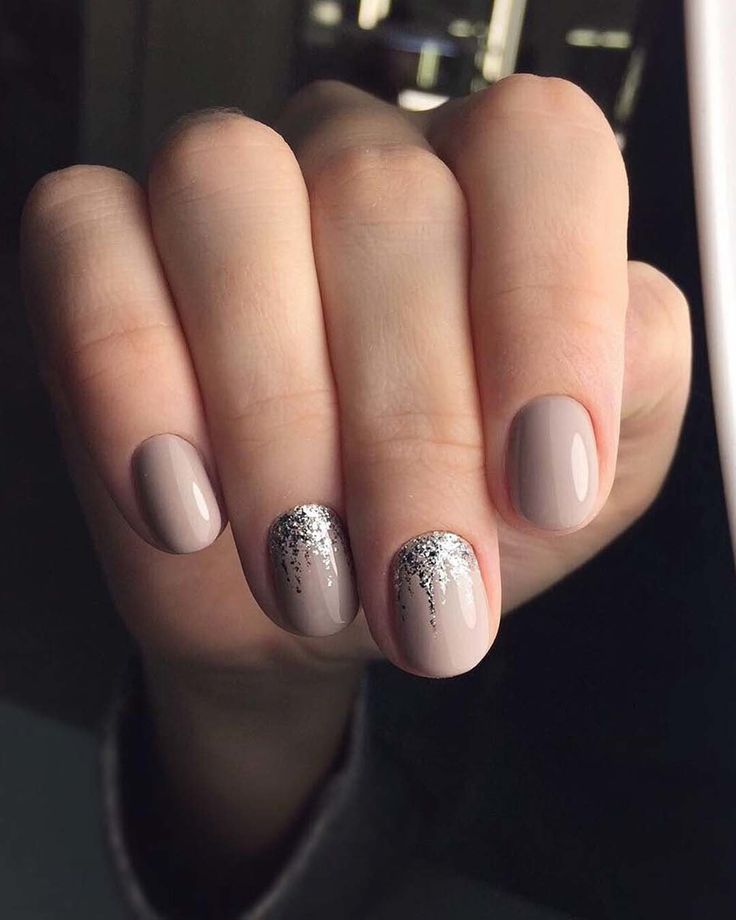 Sophisticated Taupe Nail Design with Glossy Finish and Subtle Glitter Accents.