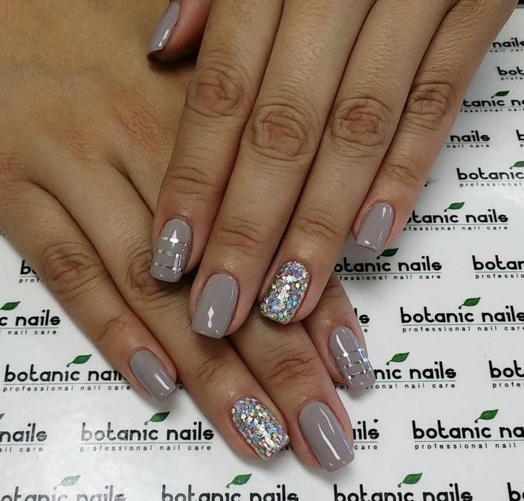 Chic Neutral Gray Nail Design with Vibrant Glitter Accent and Modern Geometric Details.