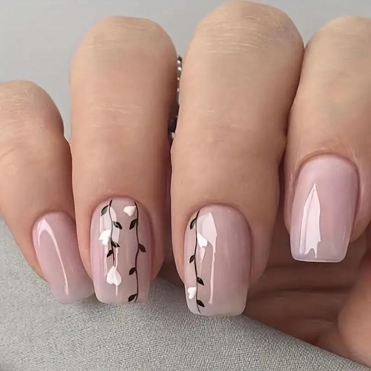 Sophisticated Soft Pink Nail Design with Delicate White Flowers and Brown Vine Accents.