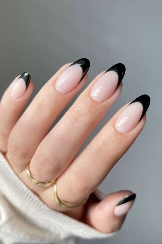 Chic French Tip Nail Design with Bold Black Tips on a Soft Nude Base.